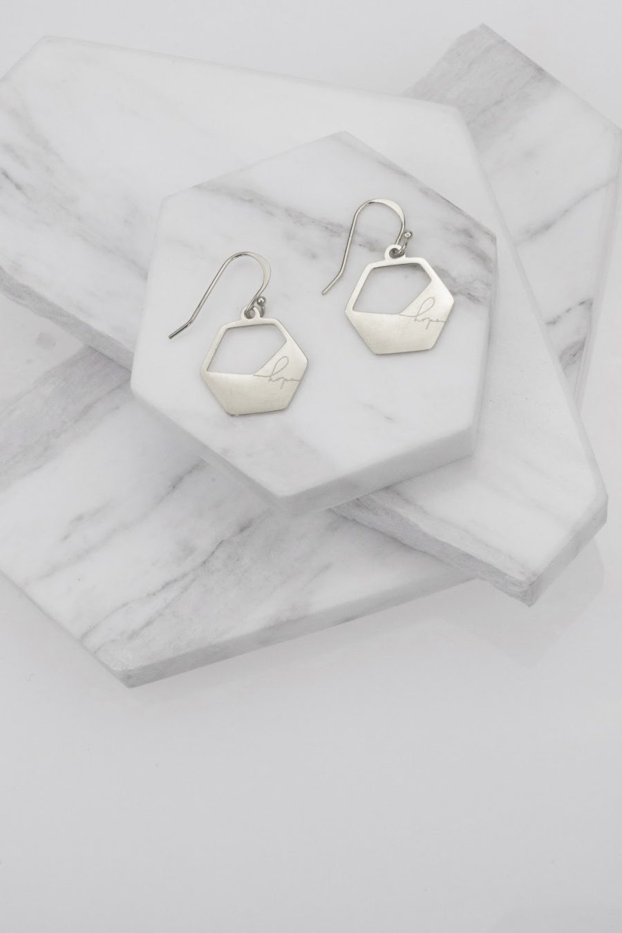 eden hope in a hexagon haymar earrings silver on marble
